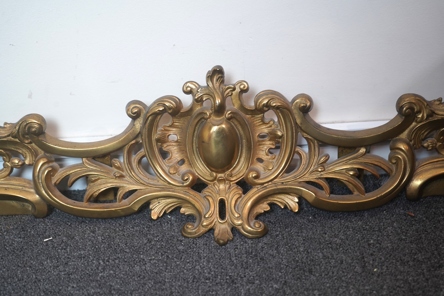 A French rococo revival ormolu adjustable fender with chenets, late 19th century